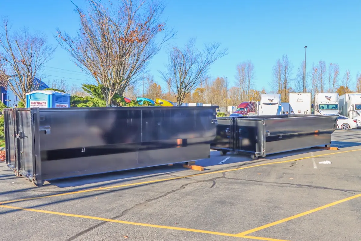 Professional dumpster rental service with roll-off container on residential driveway in Laguna Woods